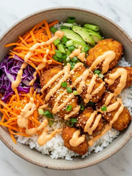 Bang Bang Chicken Bowl with sauce and colorful veggies