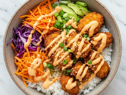 Bang Bang Chicken Bowl with sauce and colorful veggies