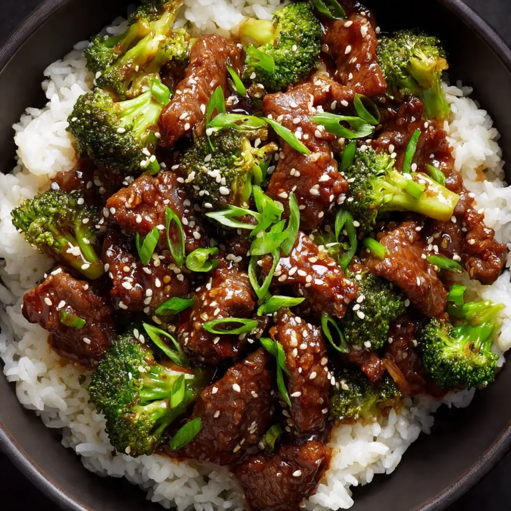 Chinese Beef and Broccoli served with rice and sesame garnish