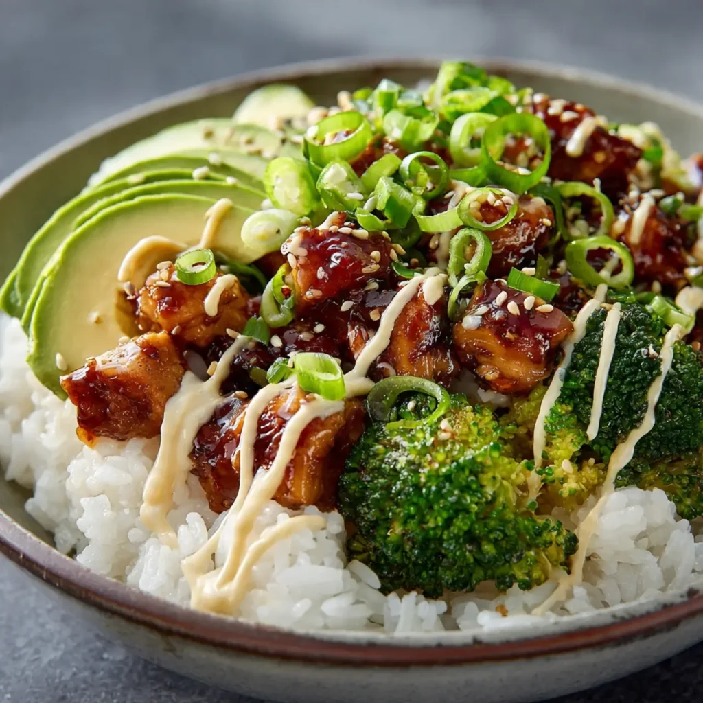 Delicious sticky chicken rice bowls recipe served with toppings